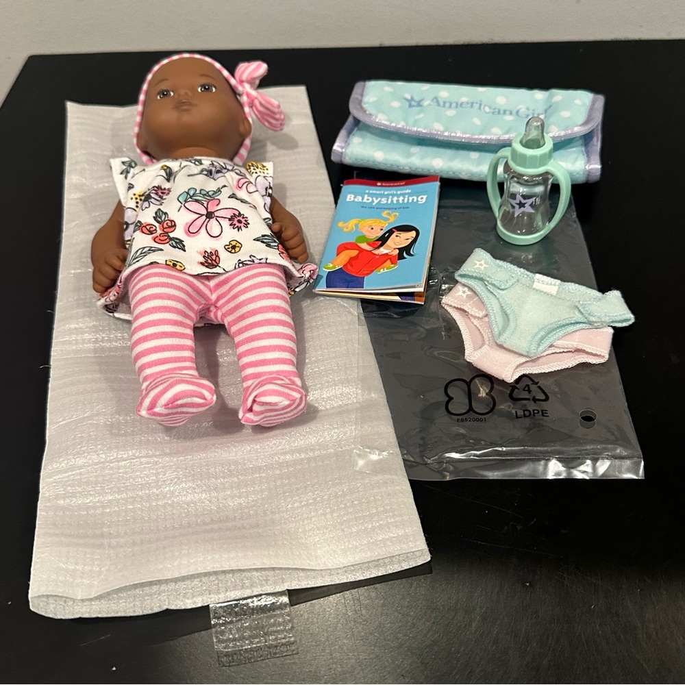 American Girl Caring for Baby Doll and Accessories